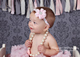Luciana- Pink Flower on a pink, grey, and white braided headband